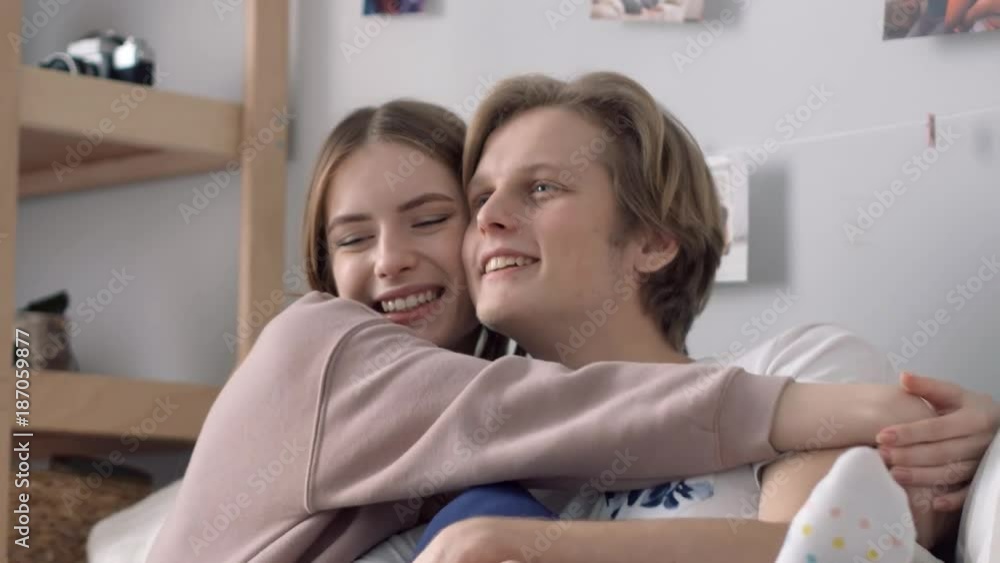 The beginning of relationships. A girl is passionately kissing her boy in his cheeck. The beginning of relationships. A girl is passionately kissing her boy in his cheeck.
