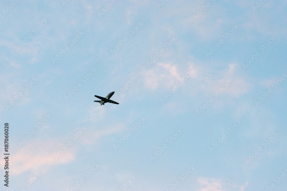 Commercial airplane flying at sunset sky Commercial airplane flying at sunset sky