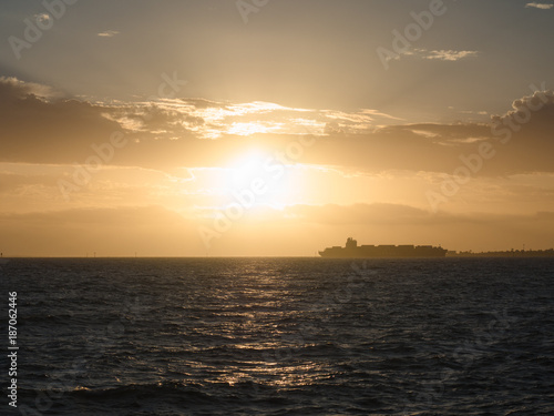 A ship passes as the sun sets in Melbourne, Australia. © Andrew Robins