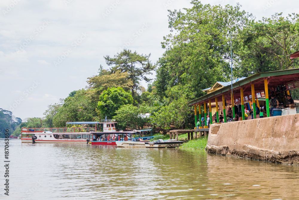 BOCA DE SABALOS, NICARAGUA - MAY 7, 2016: Boats at a pier in Boca de Sabalos village at San Juan river, Nicaragua BOCA DE SABALOS, NICARAGUA - MAY 7, 2016: Boats at a pier in Boca de Sabalos village at San Juan river, Nicaragua
