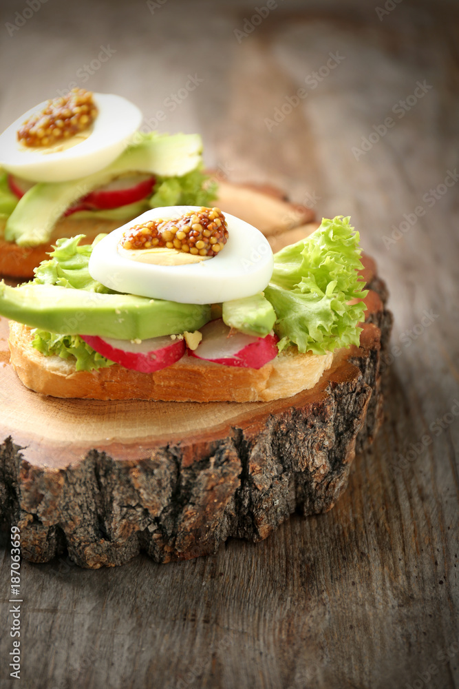 Delicious sandwich on wooden serving board, closeup