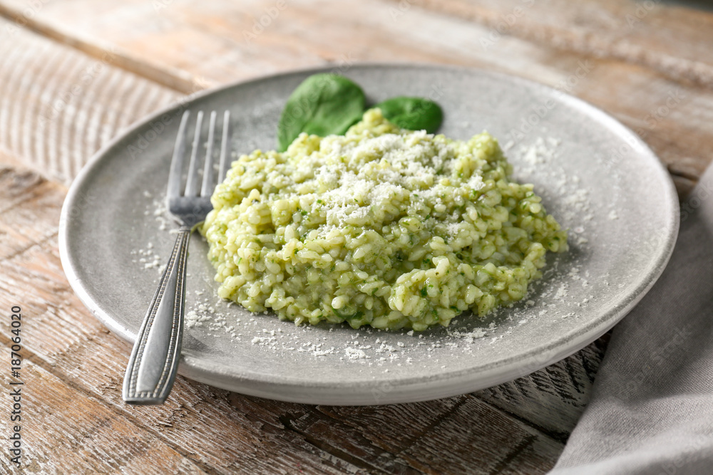 Plate with tasty spinach risotto on table, closeup Plate with tasty spinach risotto on table, closeup