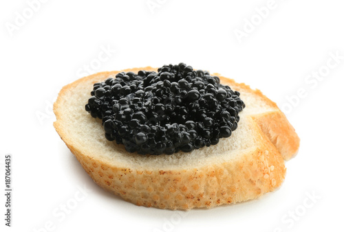 Bread with black caviar on white background