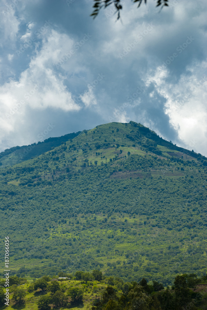 Summer landscape with mountains, cloudy sky, green grass and trees in Guatemala. Summer landscape with mountains, cloudy sky, green grass and trees in Guatemala.