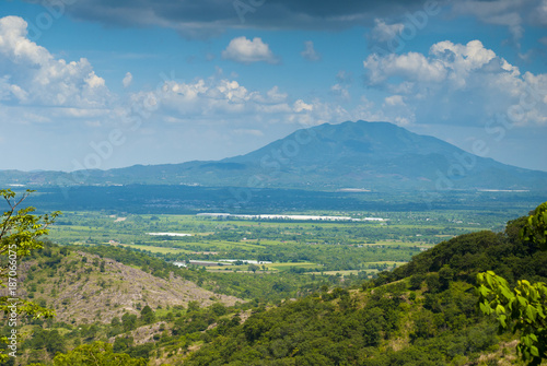 Fototapeta Naklejka Na Ścianę i Meble -  Summer landscape with mountains, cloudy sky, green grass and trees in Guatemala.