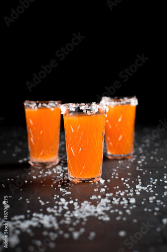 orange cocktails, salt, lemon on a dark background