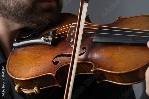 Musician man playing the violin. Musical instrument on performer hands. Classic music concept.