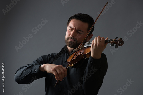 Musician man playing the violin. Musical instrument on performer hands. Classic music concept.