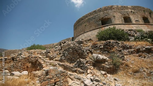 Ruins of an ancient fortress on the island of Spinalonga against the background of the sky. Cretan island of Spinalonga, location of the last leper colony in the whole of Europe. Crete. Greece