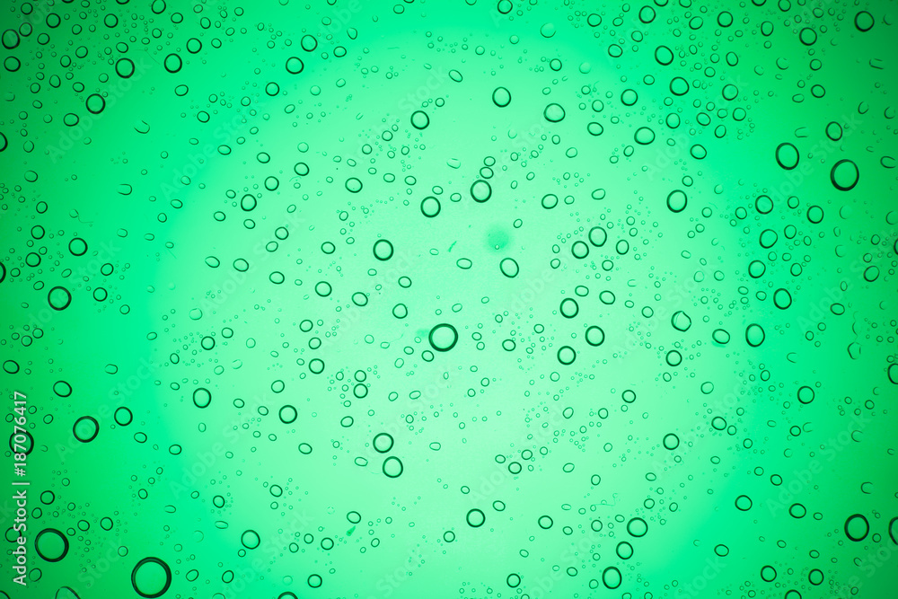 Rain droplets on green glass background, Water drops on glass.