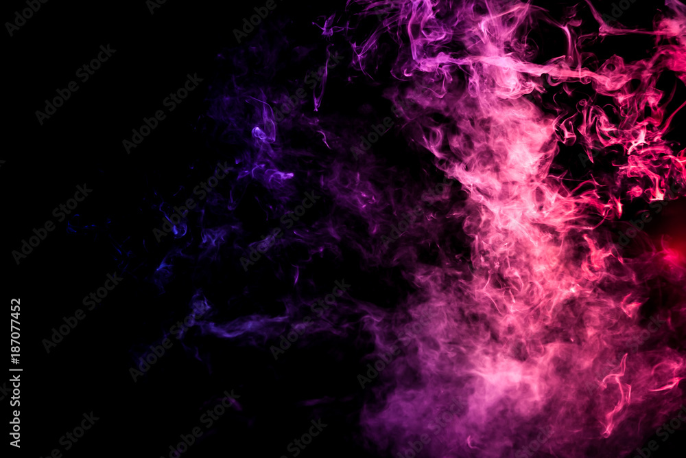 Colorful smoke of blue, pink, green on a black isolated background. Background from the smoke of wipe Colorful smoke of blue, pink, green on a black isolated background. Background from the smoke of wipe