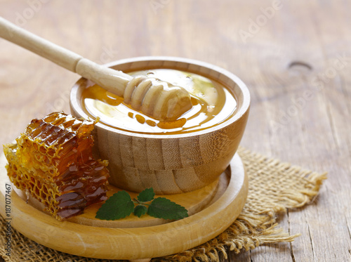 natural organic honey and honeycomb on a wooden table