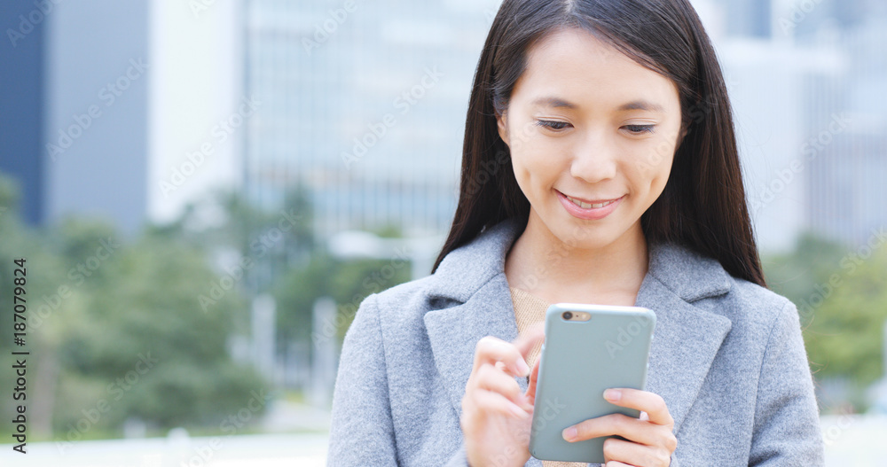 Businesswoman use of mobile phone in city Businesswoman use of mobile phone in city