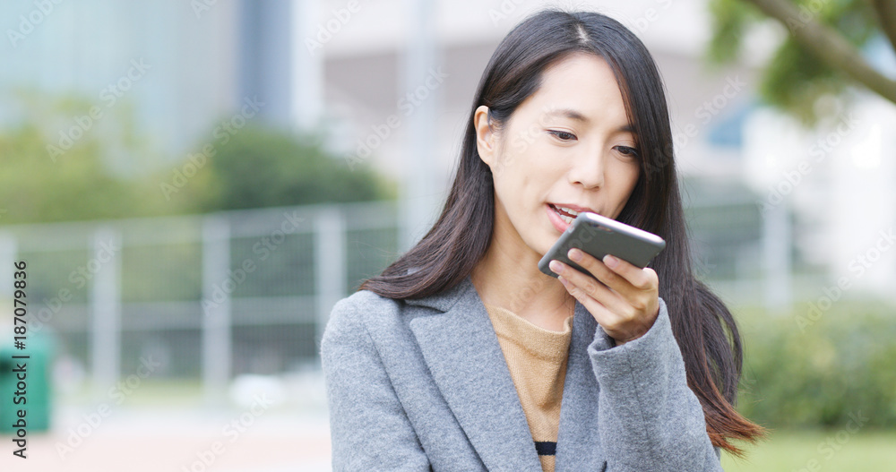 Woman sending audio message on cellphone Woman sending audio message on cellphone