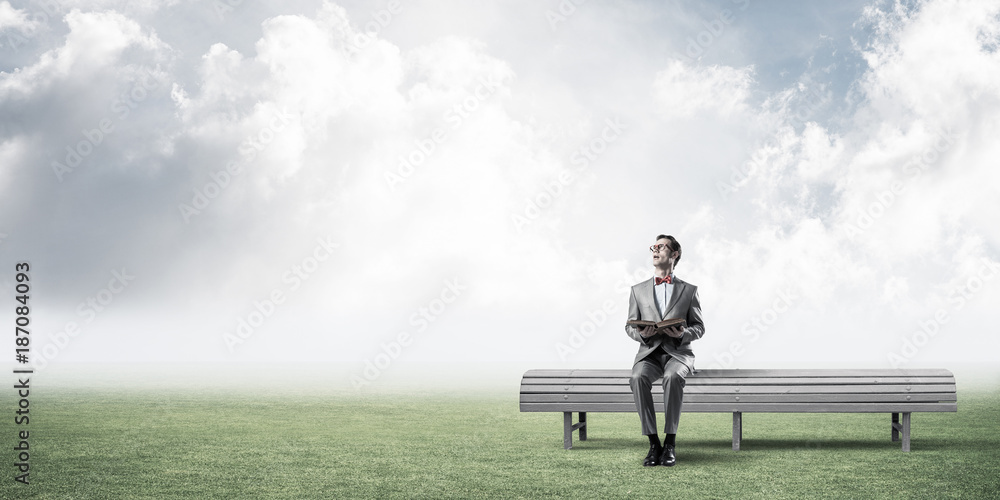 Young businessman or student studying the science in summer park Young businessman or student studying the science in summer park
