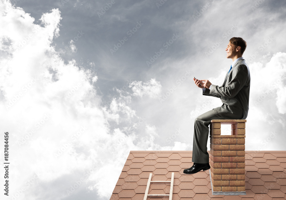 Businessman or student on brick roof smiling and making calls Businessman or student on brick roof smiling and making calls