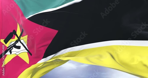 Mozambique flag waving at wind in slow in blue sky, loop photo