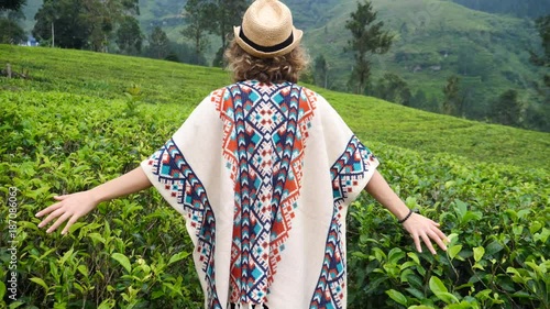 Wallpaper Mural Happy Traveler Woman In Poncho And Straw Hat Walking At Tea Plantation. Slow Motion. 4K.  Torontodigital.ca