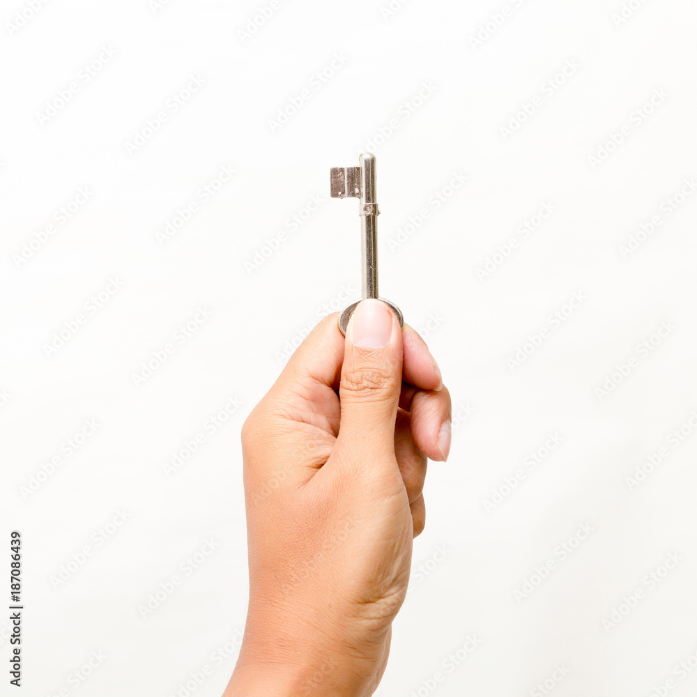Hand holding the key Isolated on white background. Studio lighting. Hand holding the key Isolated on white background. Studio lighting.