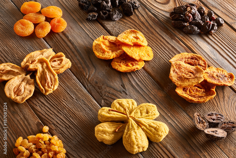 Fototapeta premium Dried fruits on wooden background
