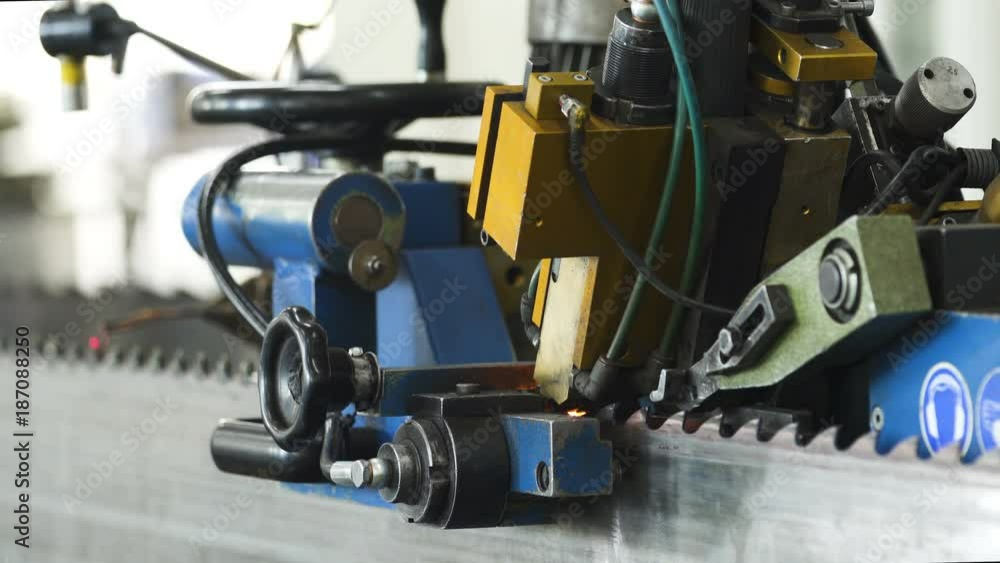 Iron processing by welding machine at the factory making a saw from steel Iron processing by welding machine at the factory making a saw from steel