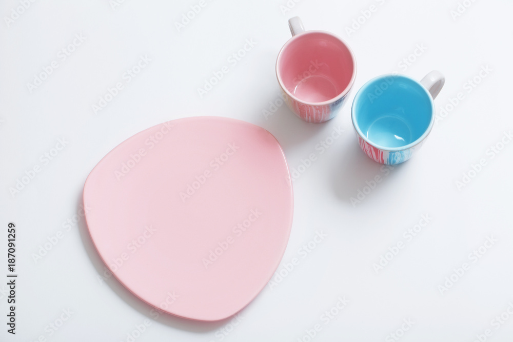 Fototapeta premium pink and blue cups on white background