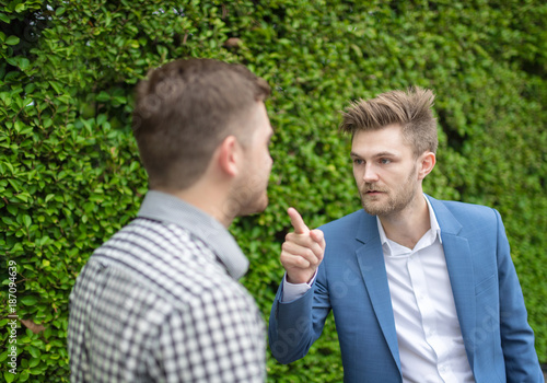 bearded business man pointing a finger to partner