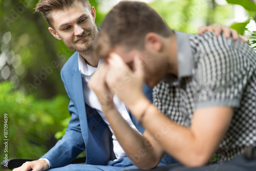Man consoling sadness friend