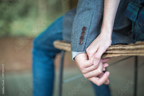Close-up hands together of young man and woman indoors