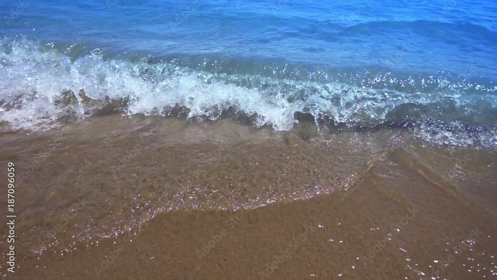 Point of view ocean splashes little waves. Top view of small waves reaching seashore. Slow motion of soft wave foam on plage. POV waves rolling in to the beach Point of view ocean splashes little waves. Top view of small waves reaching seashore. Slow motion of soft wave foam on plage. POV waves rolling in to the beach