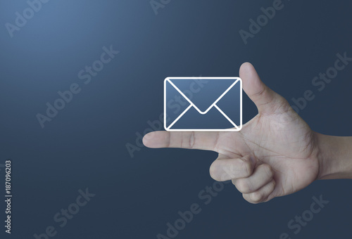 Mail icon on finger over light gradient blue background, Contact us concept
