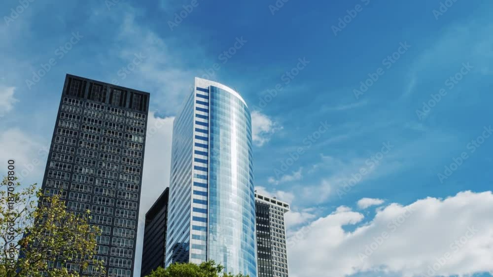 Modern office building made of glass against the sky. Modern office building made of glass against the sky.