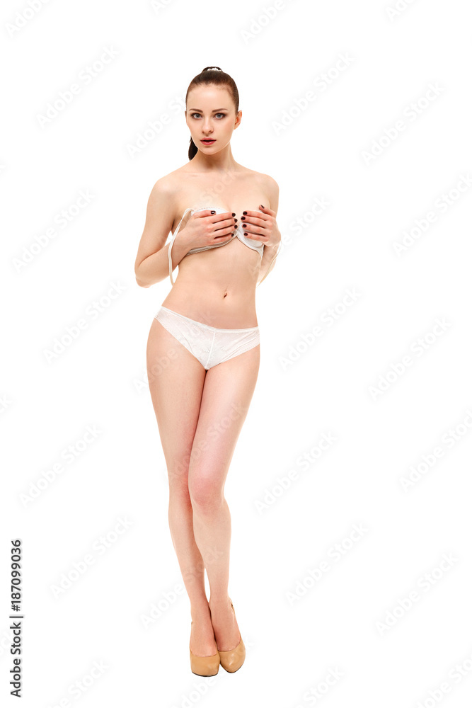 The girl takes off the bra holding it with her hands Stock Photo