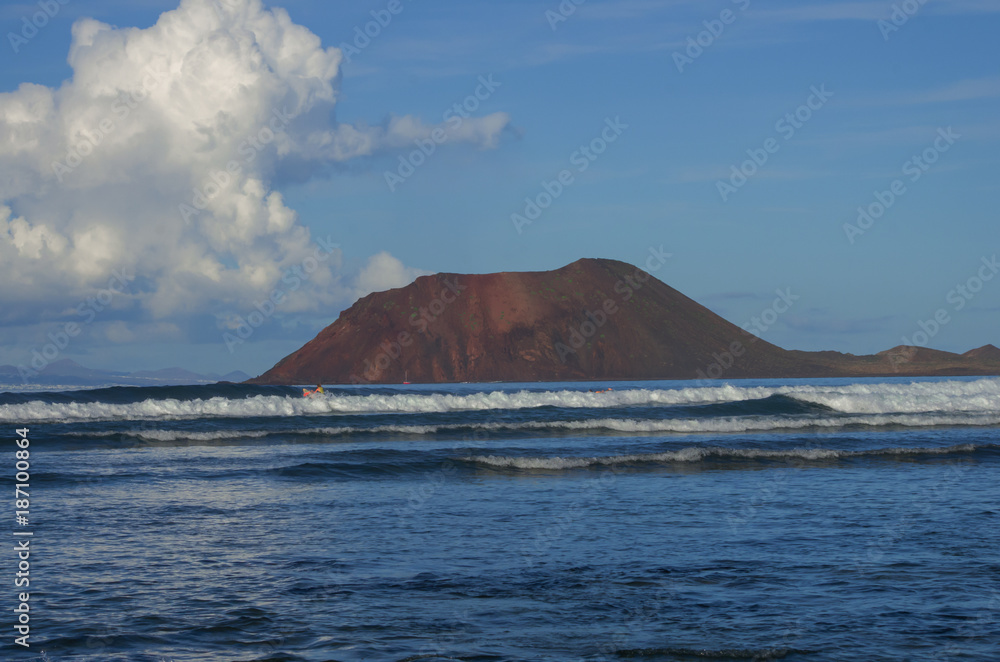Caldera mountain on the island of los lobos seen from the beach of the dunes of Fuerteventura, Canary Islands