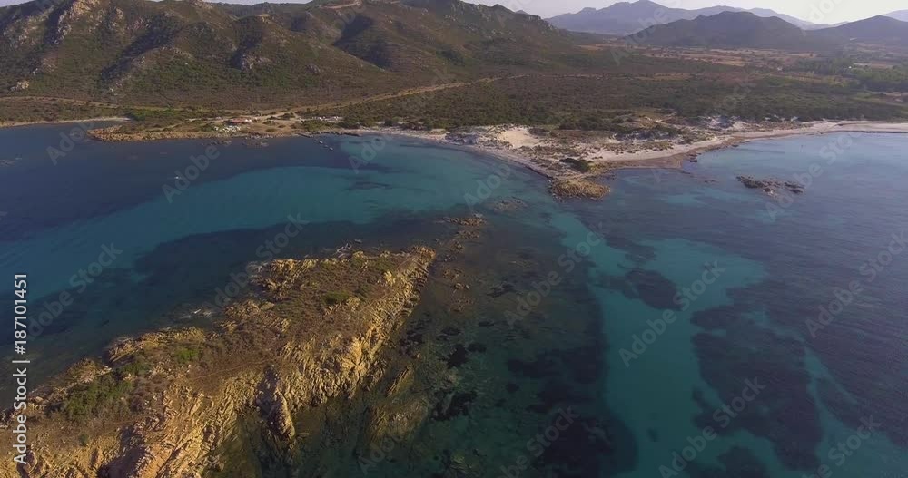 Aerial, incredibly beautiful sea at Capo Comino beach in Sardinia island in Italy Aerial, incredibly beautiful sea at Capo Comino beach in Sardinia island in Italy