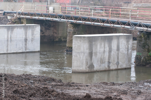 Concrete columns in the water, bridge construction on the Olt river, in Romania. © Alpar