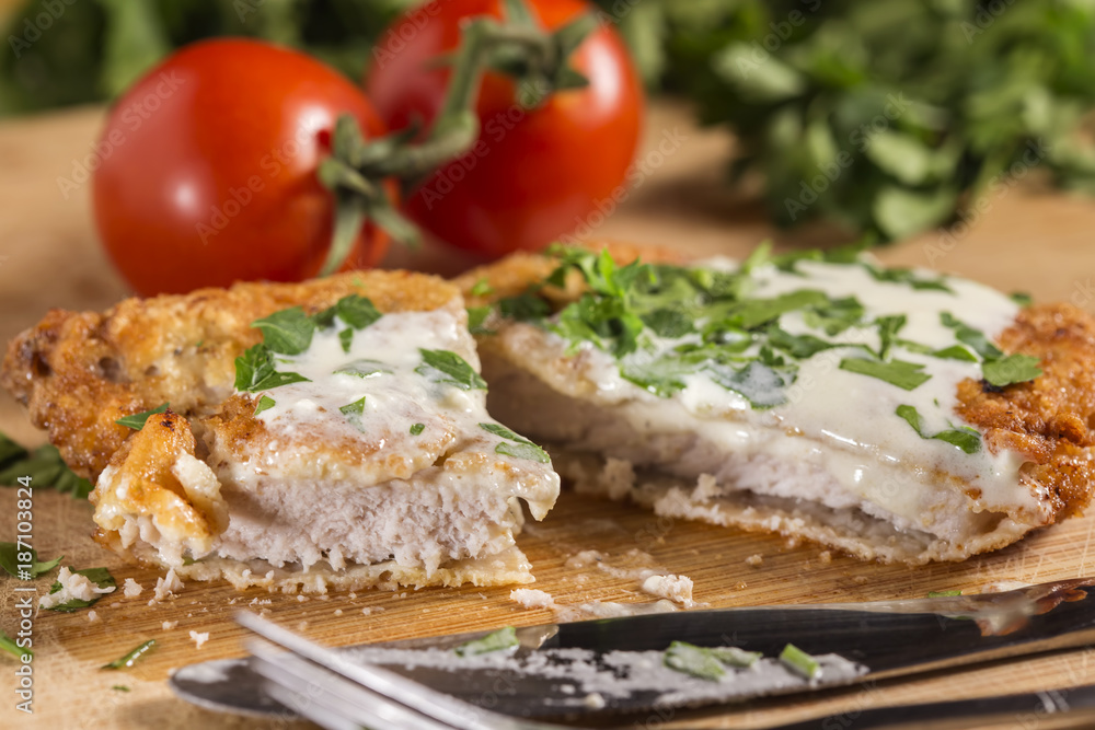 Pork schnitzel with white sauce and parsley