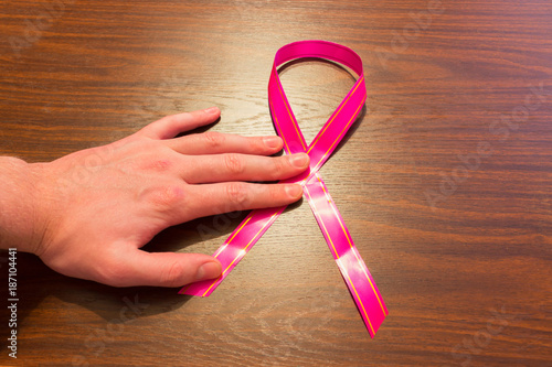 World Cancer Day: A Ribbon of Awareness about Cancer and the Hand of Man photo