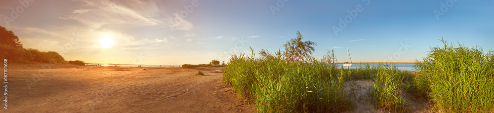 Panoramic image of a seaside by lighthouse in Swinoujscie on a sunset