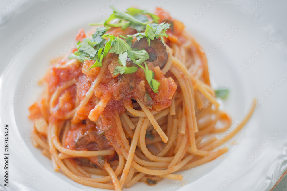 A plate of puttanesca spaghetti.