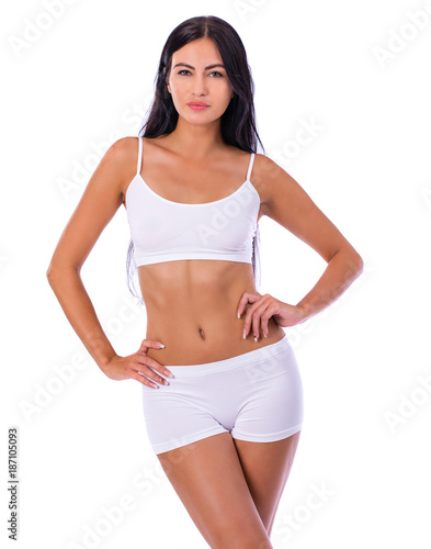 Sexy woman in white fitness clothing © Andrey_Arkusha