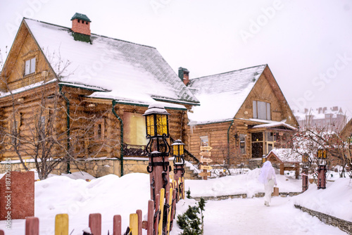Snow covered wooden house in the winter