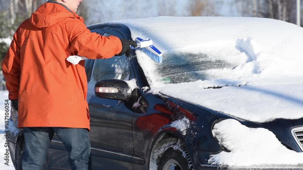 man cleaning car from snow man cleaning car from snow