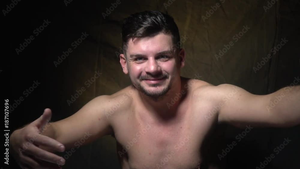A man stands topless and calls to himself, slow motion shooting A man stands topless and calls to himself, slow motion shooting