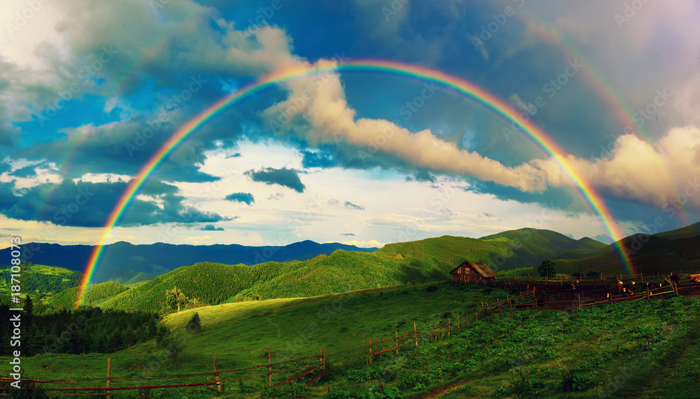 Fototapeta Beautiful mountain valley with green hills and huge rainbow in summer. Natural outdoor travel background. Carpatians, Ukraine