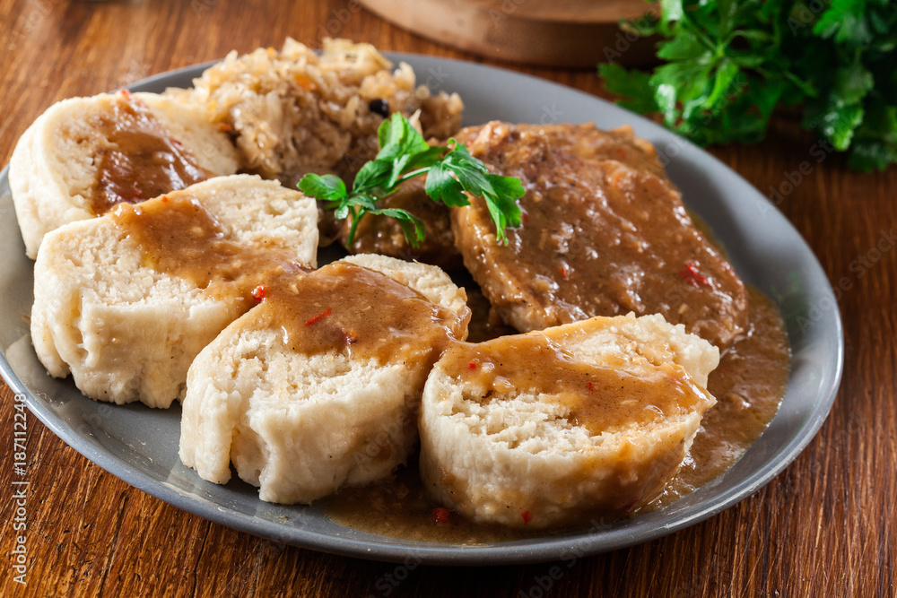 Pork loin in gravy with bread dumplings and sauerkraut Pork loin in gravy with bread dumplings and sauerkraut