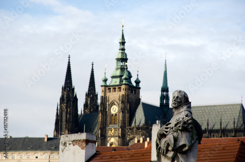 Statue on Charles Bridge with out of focus St Vitus Bridge in background
