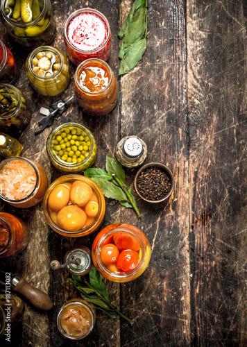 Preserved vegetables in glass jars with seamer.