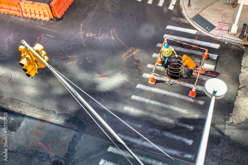 Wall Mural Industrial scene from above of non recognizable utility workers and urban inters