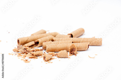 rolled wafer filled with chocolate fudge on white background,